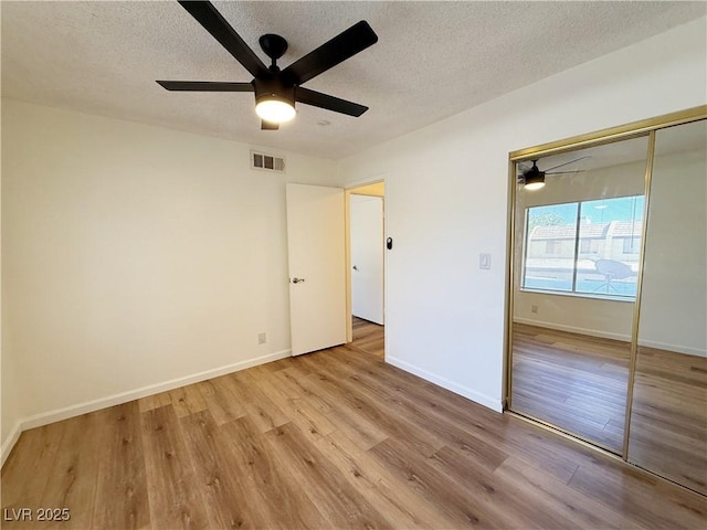 3270 Liahona Way, Las Vegas, NV 89121 - unfurnished bedroom featuring a textured ceiling, wood finished floors, a closet, and ceiling fan