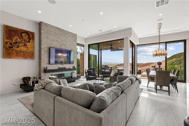 387 Solitude Peak Ln, Henderson, NV 89012 - living area featuring light marble finish floors, a chandelier, recessed lighting, and a fireplace