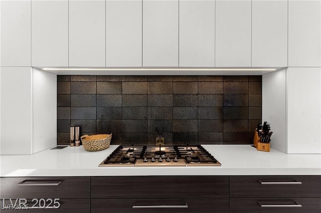 387 Solitude Peak Ln, Henderson, NV 89012 - kitchen view of modern cabinets, stainless steel gas cooktop, and white cabinets