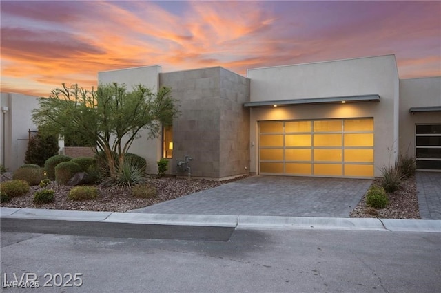 387 Solitude Peak Ln, Henderson, NV 89012 - view of front of house featuring driveway, an attached garage, and stucco siding