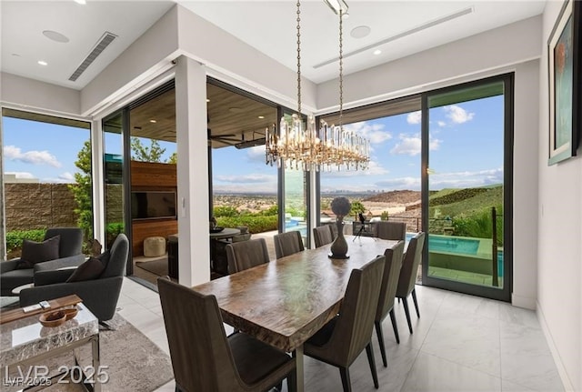 387 Solitude Peak Ln, Henderson, NV 89012 - dining area with a chandelier, light marble finish flooring, healthy amount of natural light, and recessed lighting