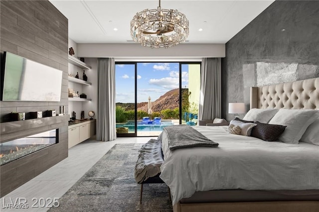 387 Solitude Peak Ln, Henderson, NV 89012 - bedroom with access to exterior, a fireplace, a chandelier, light marble finish floors, and an accent wall