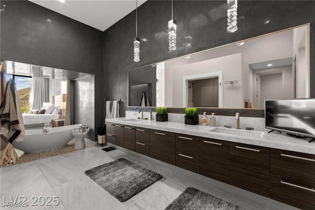 387 Solitude Peak Ln, Henderson, NV 89012 - bathroom with a towering ceiling, double vanity, a freestanding tub, and marble finish floors