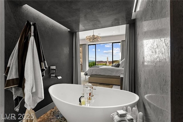387 Solitude Peak Ln, Henderson, NV 89012 - bathroom featuring a soaking tub, a textured wall, and connected bathroom