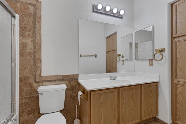 4828 Marco Polo St, North Las Vegas, NV 89031 - full bath featuring an enclosed shower, tile walls, vanity, and wainscoting