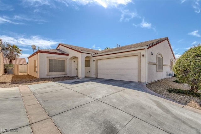 4828 Marco Polo St, North Las Vegas, NV 89031 - mediterranean / spanish house featuring driveway, an attached garage, stucco siding, and a tile roof