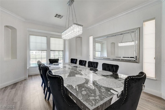 2496 Ram Crossing Way, Henderson, NV 89074 - dining area with ornamental molding, a chandelier, and light wood-type flooring
