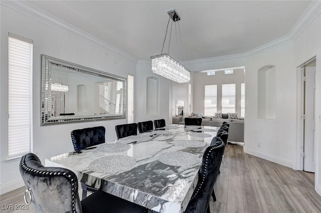 2496 Ram Crossing Way, Henderson, NV 89074 - dining area with ornamental molding, wood finished floors, and a chandelier