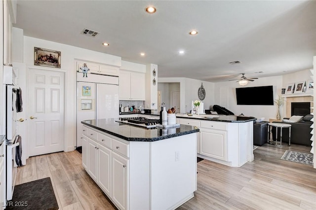 2496 Ram Crossing Way, Henderson, NV 89074 - kitchen featuring a kitchen island, a ceiling fan, open floor plan, white cabinets, and recessed lighting
