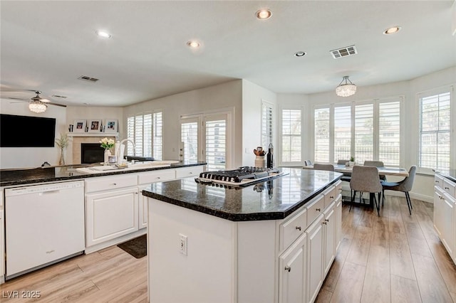 2496 Ram Crossing Way, Henderson, NV 89074 - kitchen featuring dishwasher, a ceiling fan, a fireplace, plenty of natural light, and recessed lighting