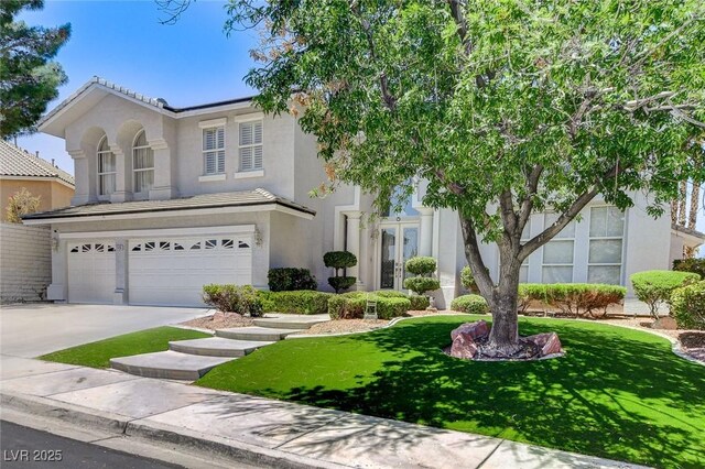 2496 Ram Crossing Way, Henderson, NV 89074 - view of front facade with an attached garage, a front lawn, driveway, stucco siding, and a tile roof