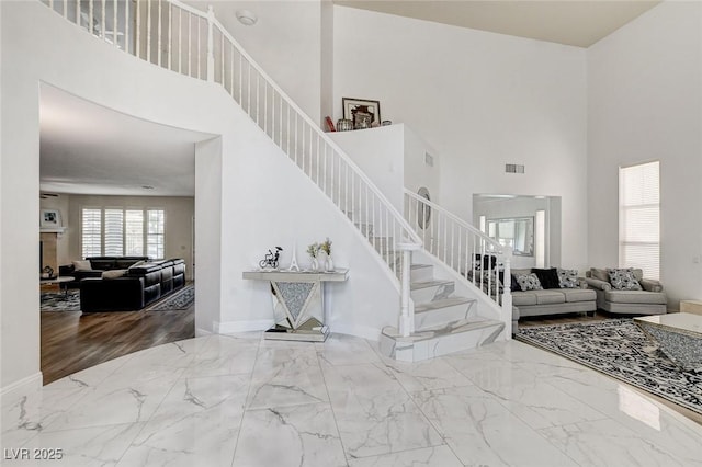 2496 Ram Crossing Way, Henderson, NV 89074 - stairs featuring a high ceiling and marble finish flooring