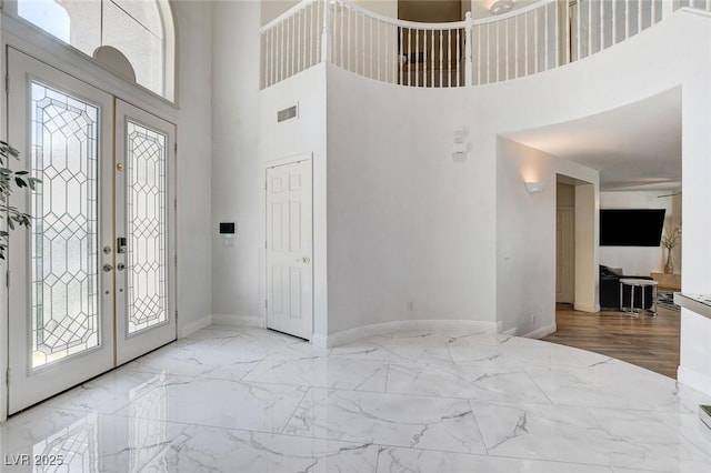 2496 Ram Crossing Way, Henderson, NV 89074 - foyer featuring a towering ceiling, plenty of natural light, marble tiled flooring, and french doors