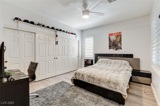 2496 Ram Crossing Way, Henderson, NV 89074 - bedroom with wood finished floors, multiple windows, a closet, and ceiling fan