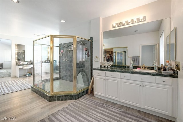 2496 Ram Crossing Way, Henderson, NV 89074 - bathroom featuring wood finished floors, vanity, a shower stall, and recessed lighting