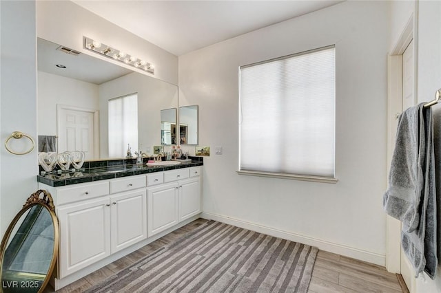 2496 Ram Crossing Way, Henderson, NV 89074 - full bath with wood finished floors and vanity