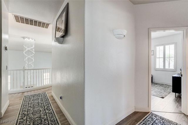 2496 Ram Crossing Way, Henderson, NV 89074 - hallway with wood finished floors and a chandelier