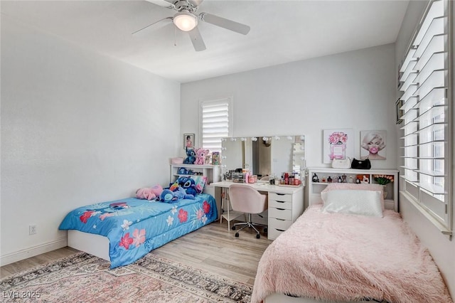 2496 Ram Crossing Way, Henderson, NV 89074 - bedroom featuring wood finished floors, multiple windows, an office area, and a ceiling fan