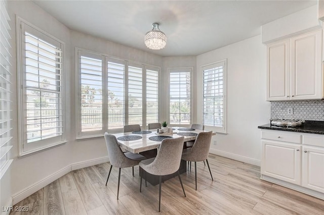 2496 Ram Crossing Way, Henderson, NV 89074 - dining room with plenty of natural light, light wood-style floors, and a chandelier