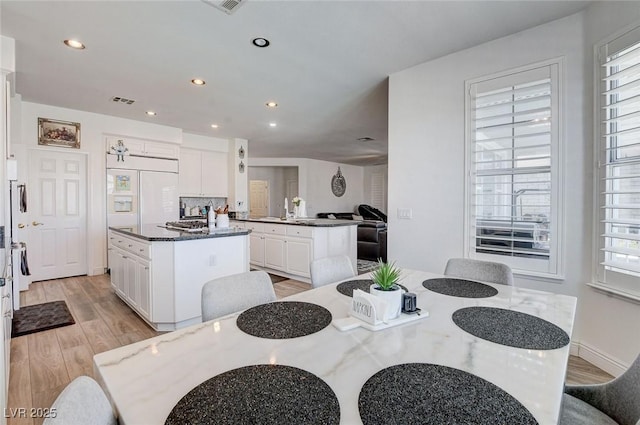 2496 Ram Crossing Way, Henderson, NV 89074 - dining room featuring light wood finished floors, plenty of natural light, and recessed lighting