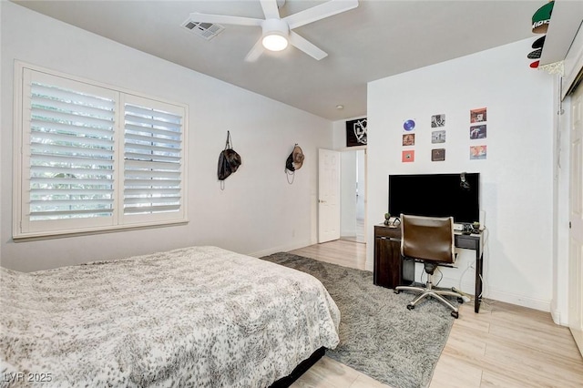 2496 Ram Crossing Way, Henderson, NV 89074 - bedroom with wood finished floors, an office area, and ceiling fan