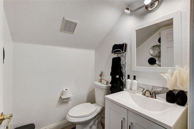 2496 Ram Crossing Way, Henderson, NV 89074 - bathroom featuring vanity, vaulted ceiling, and a textured wall