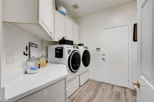 2496 Ram Crossing Way, Henderson, NV 89074 - laundry room featuring cabinet space, washing machine and clothes dryer, and light wood-style flooring