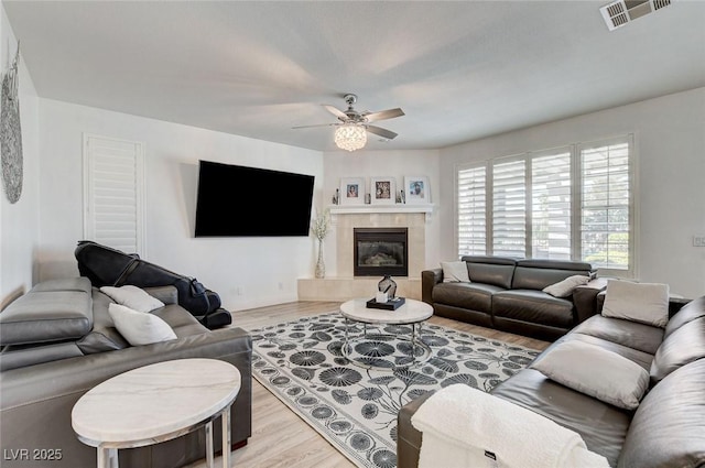 2496 Ram Crossing Way, Henderson, NV 89074 - living room featuring a ceiling fan, wood finished floors, and a fireplace