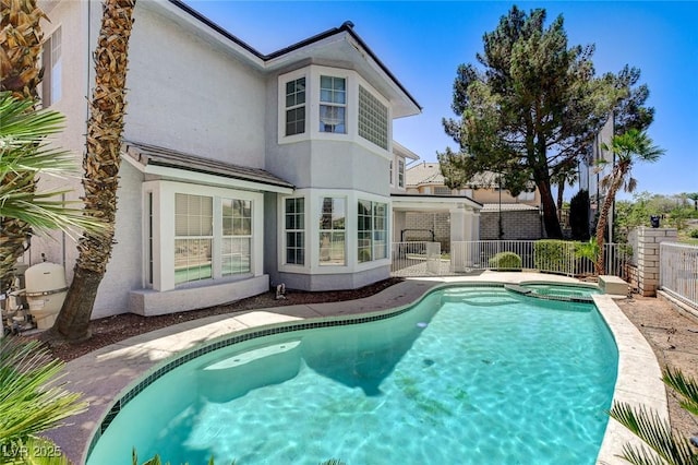 2496 Ram Crossing Way, Henderson, NV 89074 - back of house featuring stucco siding and a pool with connected hot tub