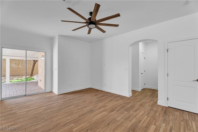 9047 Harbor Wind Ave, Las Vegas, NV 89178 - spare room with arched walkways, a ceiling fan, and light wood-type flooring