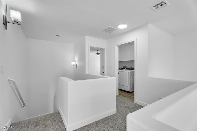 9047 Harbor Wind Ave, Las Vegas, NV 89178 - hallway featuring an upstairs landing, washer and clothes dryer, and carpet flooring