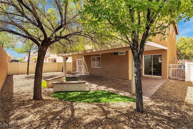9047 Harbor Wind Ave, Las Vegas, NV 89178 - back of property with a fenced backyard, stucco siding, and a patio area