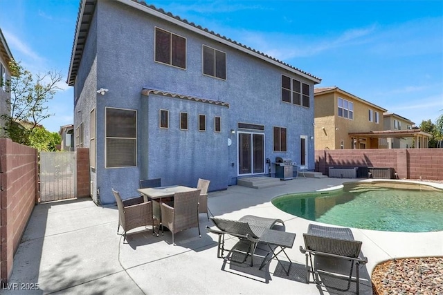 9408 Ironsend St, Las Vegas, NV 89143 - back of property with stucco siding, a fenced backyard, a patio area, entry steps, and a tile roof