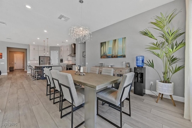 112 Springbough Ln, Las Vegas, NV 89138 - dining area with light wood-type flooring, a chandelier, and recessed lighting