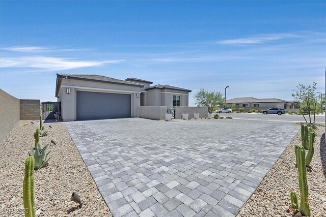 112 Springbough Ln, Las Vegas, NV 89138 - view of front of home featuring a gate, a garage, stucco siding, decorative driveway, and a tile roof