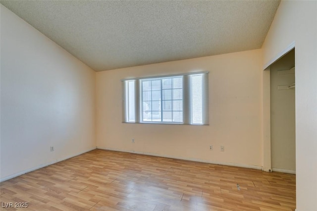 3127 Kennewick Dr, Las Vegas, NV 89121 - unfurnished bedroom with wood finished floors, a textured ceiling, and lofted ceiling