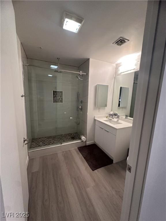353 E Bonneville Ave Unit 449, Las Vegas, NV 89101 - full bath featuring wood finished floors, a shower stall, and vanity