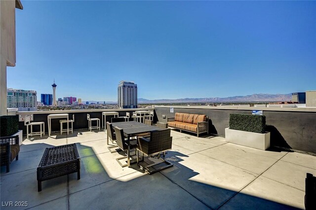 353 E Bonneville Ave Unit 449, Las Vegas, NV 89101 - view of patio featuring an outdoor living space, a mountain view, and a city view