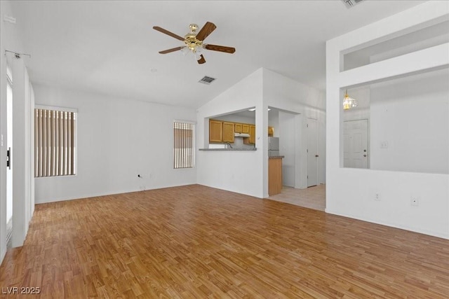 2154 Eagle Sticks Dr, Henderson, NV 89012 - unfurnished living room featuring light wood-style flooring, lofted ceiling, and a ceiling fan