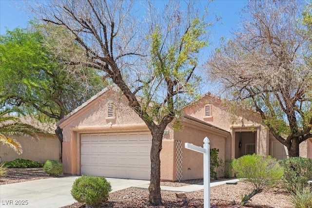 2154 Eagle Sticks Dr, Henderson, NV 89012 - view of front of home with a garage, driveway, and stucco siding