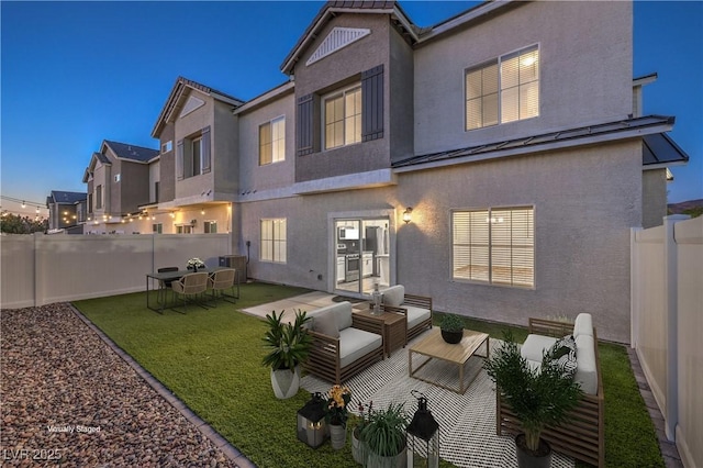 545 Thea St Unit 1315, Henderson, NV 89052 - back of house with stucco siding, a standing seam roof, a fenced backyard, a metal roof, and an outdoor hangout area