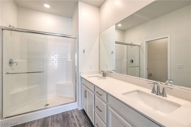 545 Thea St Unit 1315, Henderson, NV 89052 - bathroom with a stall shower, double vanity, wood finished floors, and recessed lighting