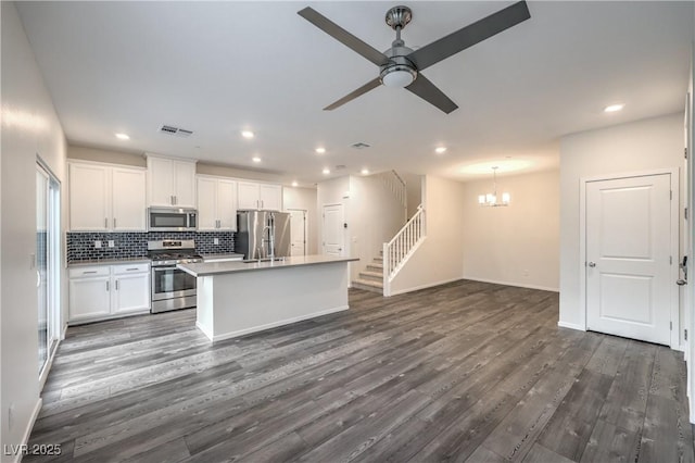 545 Thea St Unit 1315, Henderson, NV 89052 - kitchen featuring stainless steel appliances, dark wood finished floors, white cabinets, a ceiling fan, and a chandelier