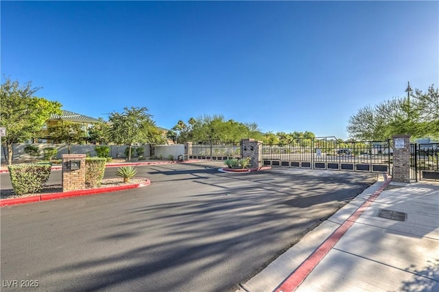 545 Thea St Unit 1315, Henderson, NV 89052 - view of asphalt street with a gate, curbs, and a gated entry