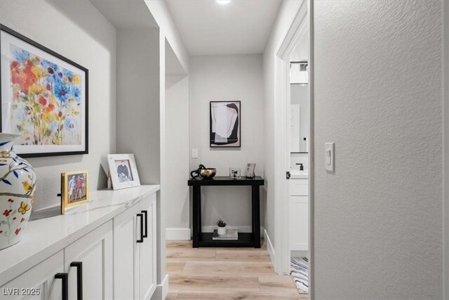 9540 Eagle Valley Dr, Las Vegas, NV 89134 - corridor with light wood-type flooring and a textured wall
