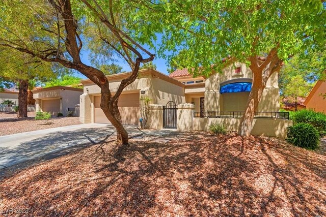 9540 Eagle Valley Dr, Las Vegas, NV 89134 - view of front facade with driveway, a garage, stucco siding, a gate, and a tile roof