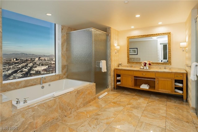 2000 Fashion Show Dr Unit 5022, Las Vegas, NV 89109 - full bathroom featuring double vanity, a garden tub, a shower stall, recessed lighting, and a mountain view