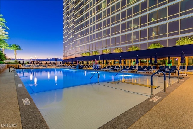 2000 Fashion Show Dr Unit 5022, Las Vegas, NV 89109 - pool at dusk featuring a community pool