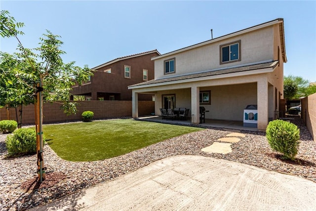 1034 Fish Pond Ave, Henderson, NV 89014 - back of property with stucco siding, a patio area, and a fenced backyard
