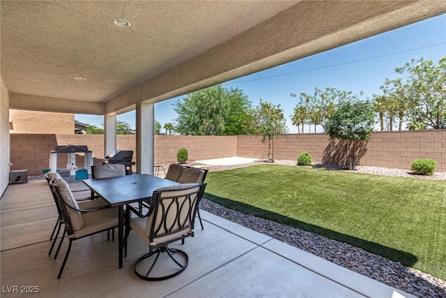 1034 Fish Pond Ave, Henderson, NV 89014 - fenced backyard with a patio and outdoor dining area